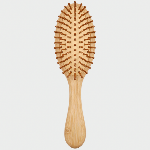 A wooden hairbrush with a light natural bamboo handle and bristles, shown vertically against a solid light gray background.
